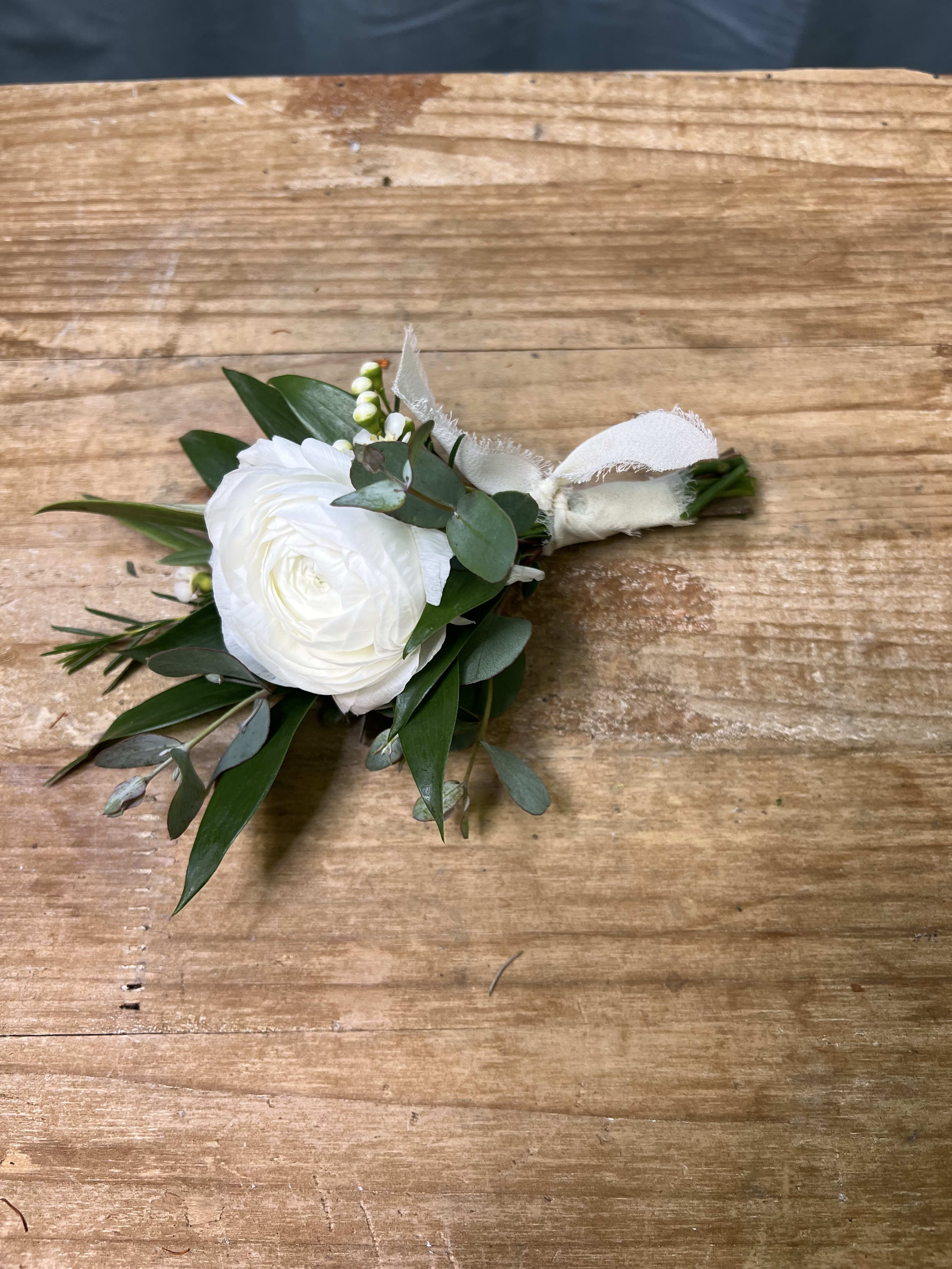 Classic White Boutonnière Classic White Boutonnière - Elegant lisianthus, greenery, and premium accent blooms. Stem wrapped in ribbon.