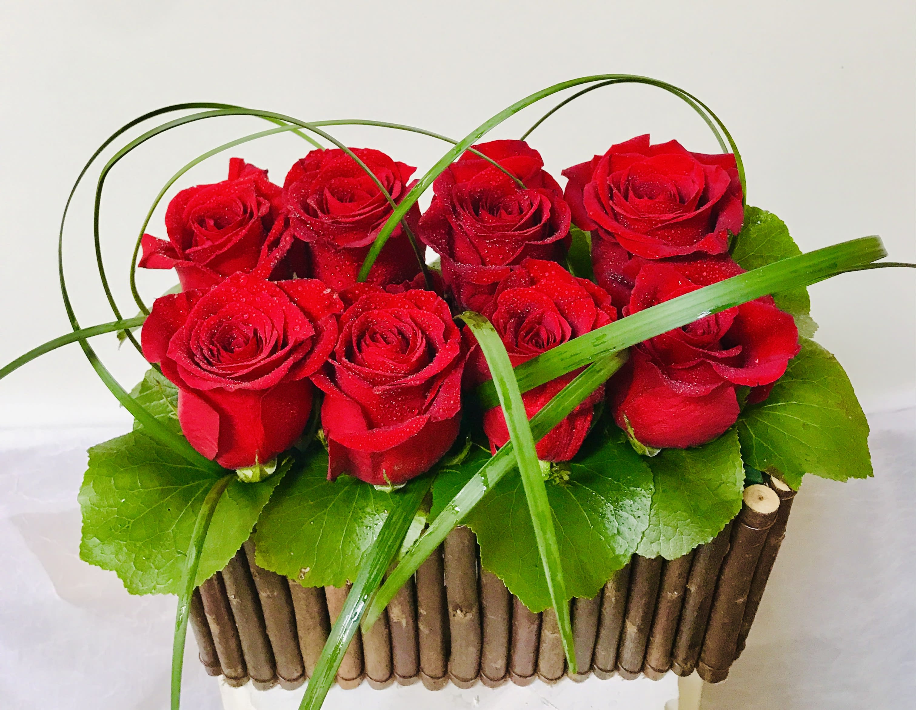 Love Happens  - 8 red roses in a fancy wood basket 