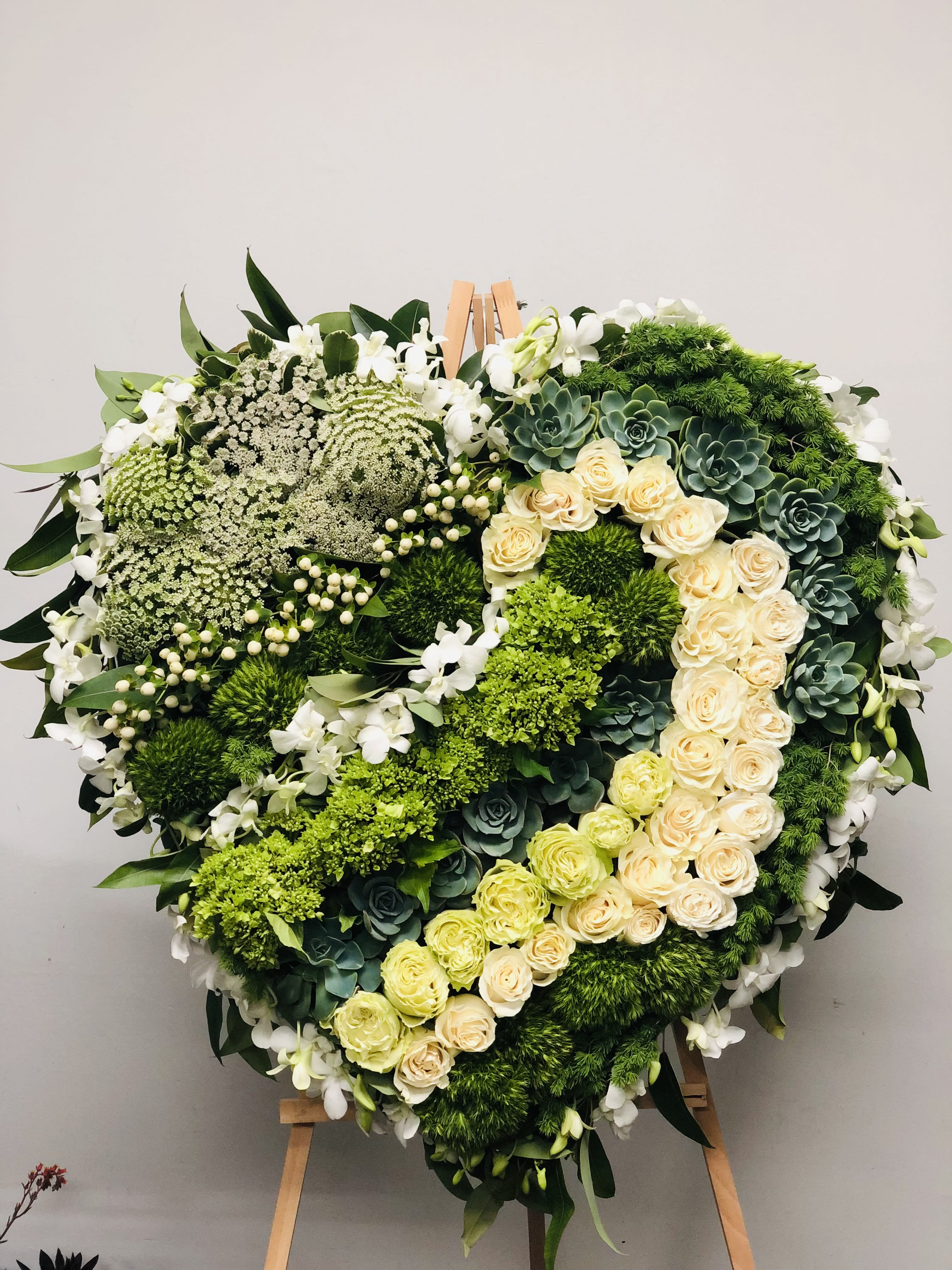 Loving Heart - Large Standing Heart Spray. Striking floral expression of the impact that the departed has had on your life.