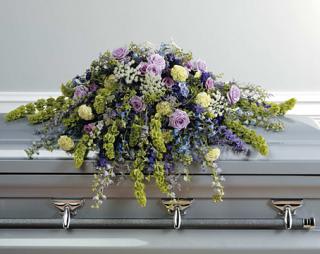 Purple Wildflower Spray - This beautiful purple wildflower casket spray is full of various wildflowers bringing comfort and peace during this difficult time of loss. Lavender roses, blue delphinium, pale green carnations, purple larkspur, Bells of Ireland and blue hydrangea make a stunning appearance.