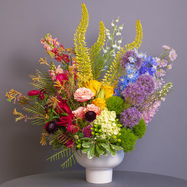 Kaleidoscope Queen - Our &quot;Kaleidoscope Queen&quot; is a beautiful, fresh-cut arrangement! Enjoy a rainbow of colors in a contemporary vase. This PRIDE themed arrangement is only available for a limited time, so don't delay in bringing this beauty home, or gifting her to your best Judy!