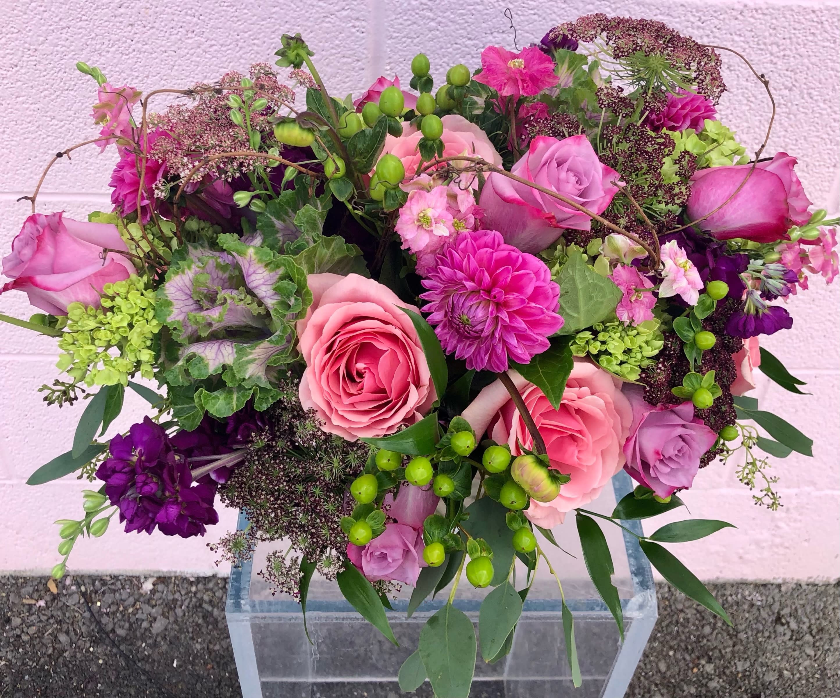 Blush Blush Baby - The perfect combination of pinks sure to make anyone blush! This arrangement may include roses, dahlias, cabbage and other beautifully toned elements.  Due to the ever changing market and seasons substitutions may be made but will keep the feel, shape and color of arrangement. 