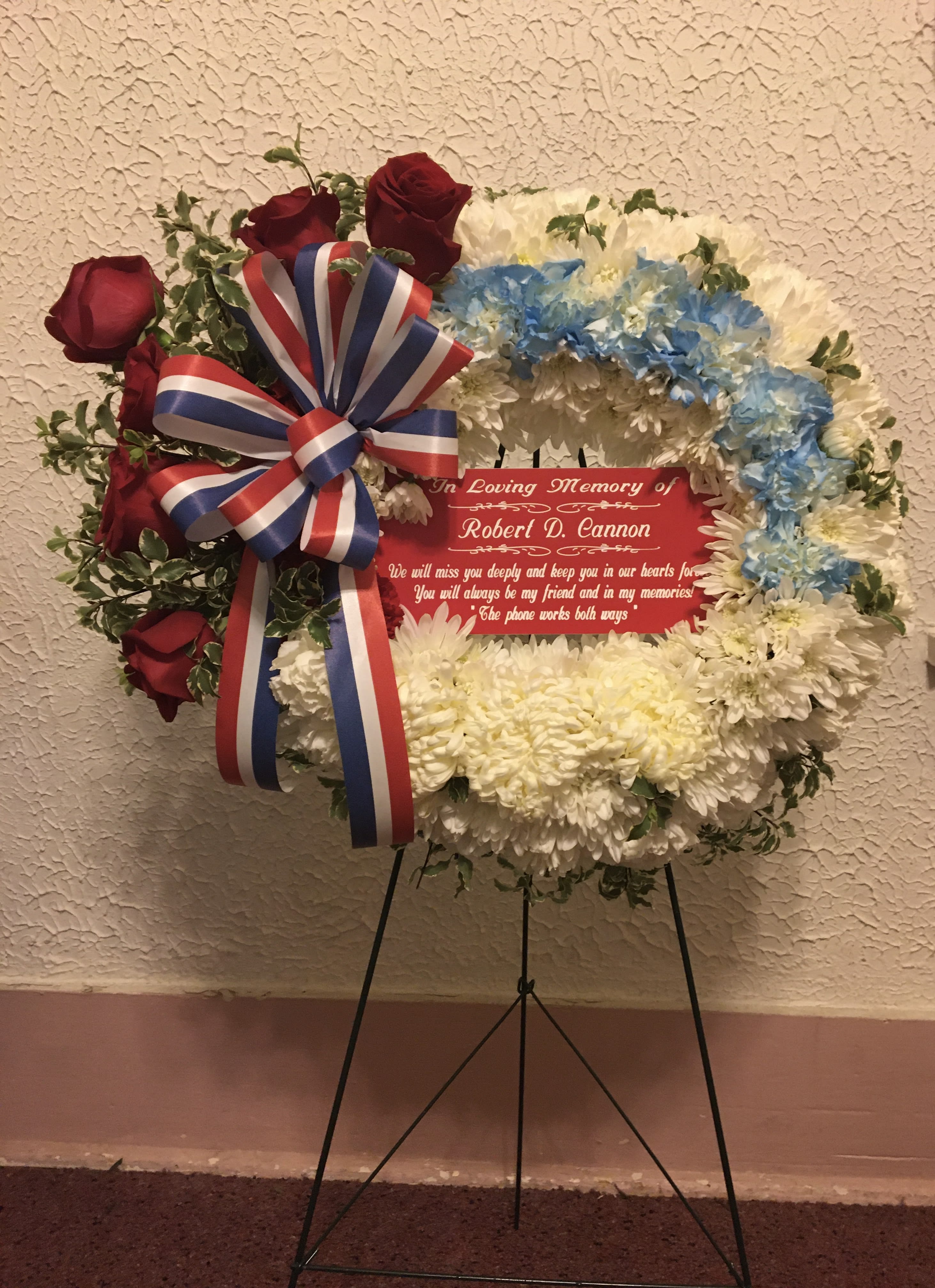 Remembrance Wreath - Arrangement includes roses, carnations, mums, filler, assorted greenery and a bow placed on an easel