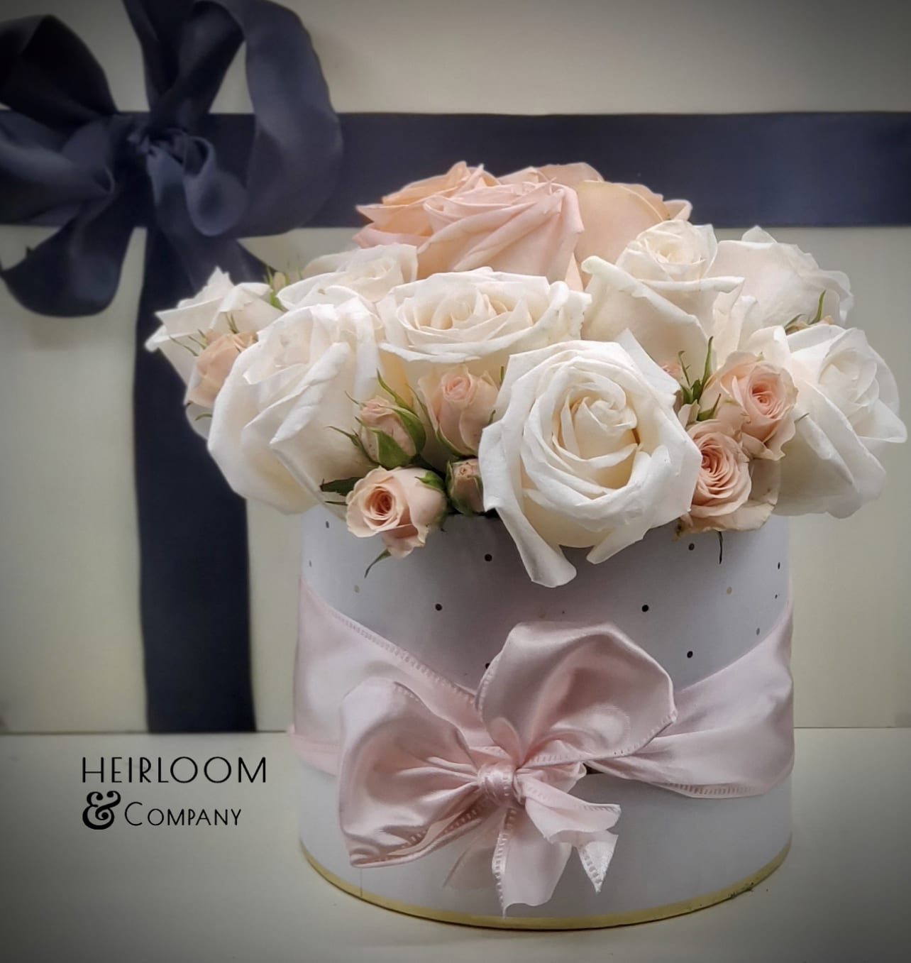 Natalie - The perfect blush hatbox, filled with a variety of our prermium roses, mini roses, and lush garden roses In a white and gold hatbox.