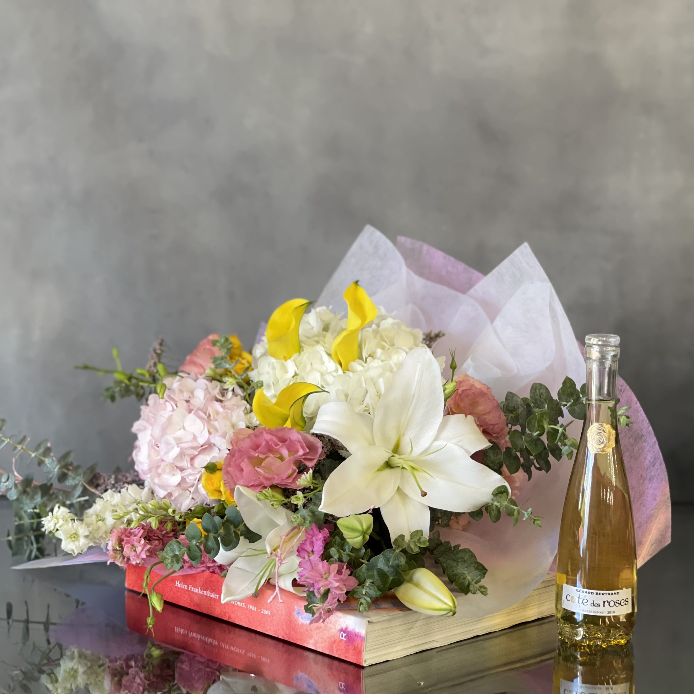 Mixed Lily Bouquet  - A beautiful mixed Bouquet with Lilies, Hydrangeas, Eucalyptus and various seasonal blooms. A mixed bouquet with a bright touch wrapped with our floral wrapping paper. 