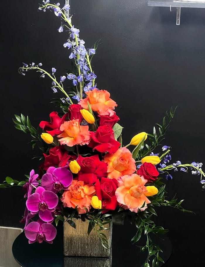 Conquista - Roses, Purple Phalaenopsis, Tulips, Delphinium, Butcher’s Broom, Golden Ceramic Base.