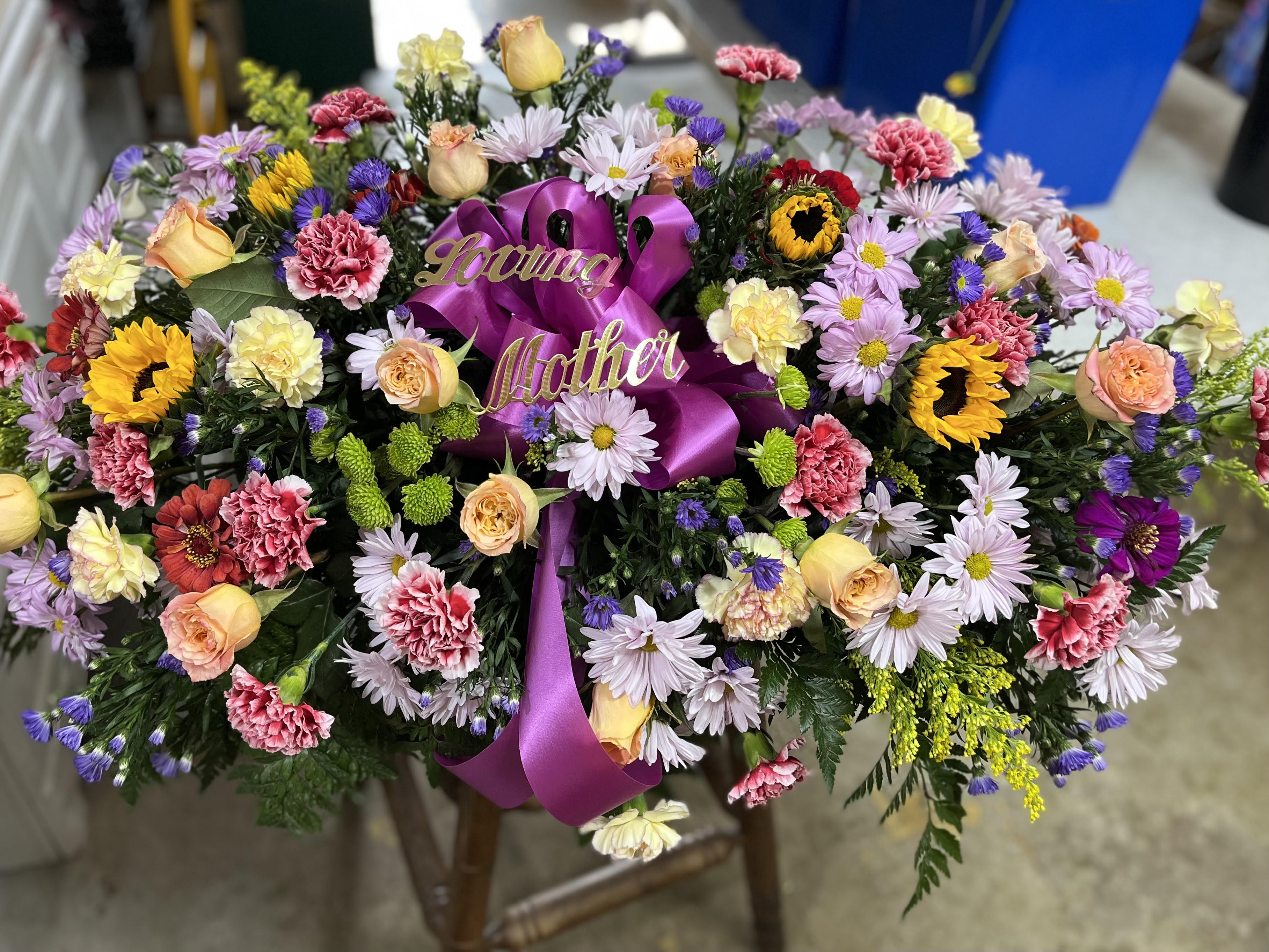 Over The Rainbow Casket Spray Over The Rainbow Casket Spray - A colorful reflection of a joyful life, this colorful piece brings a rainbow of hope to the service.