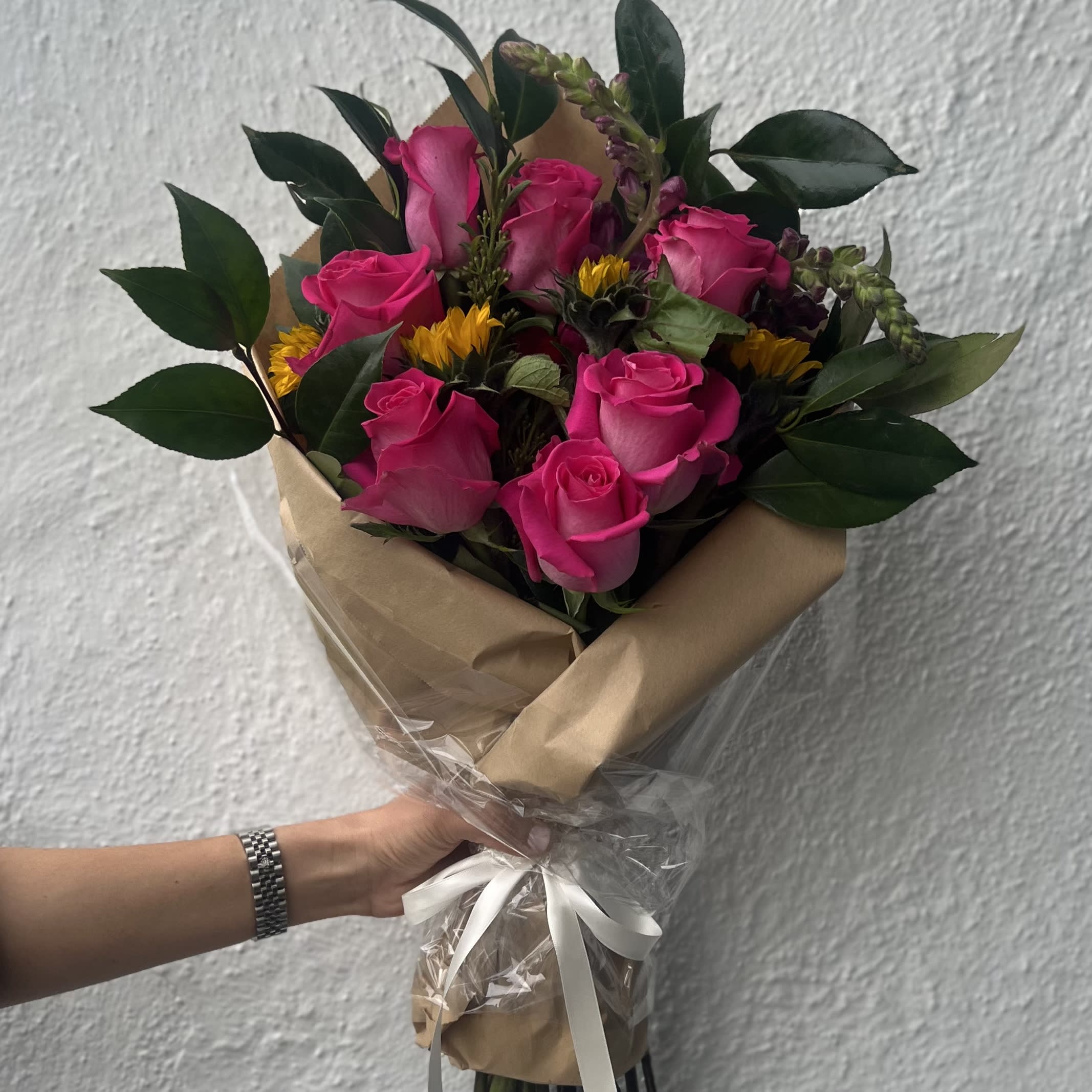 PINK BOUQUET  - This is a hand tied bouquet that has a mix of roses and summer flowers. 