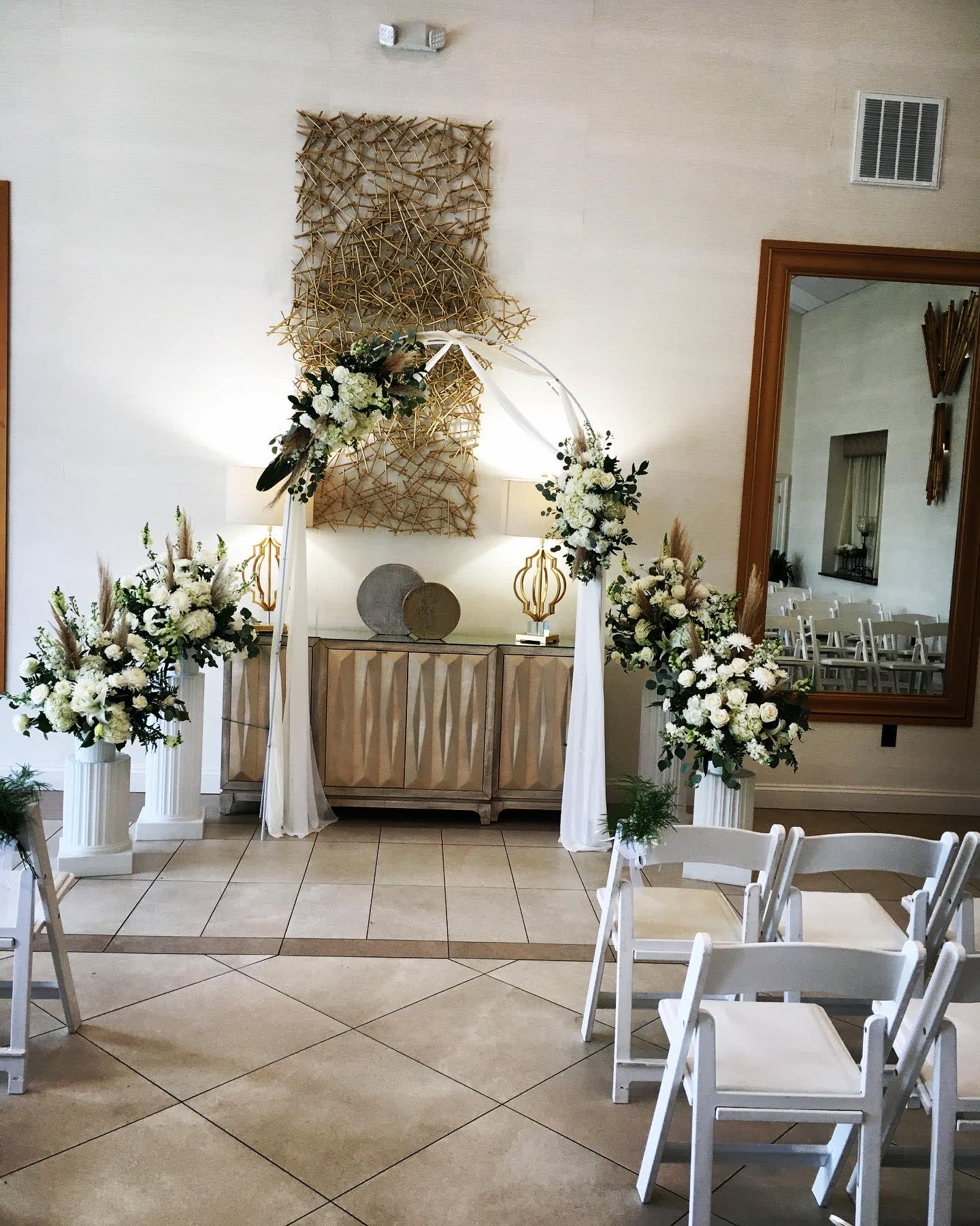 Wedding ceremony package  - All white seasonal flowers. Includes 4 baskets , 2 flower pieces for arch and ivory / white fabric  ( metal arch not included) and rental and retrieval of white columns 