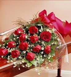 Red Roses/One Dozen Presentation Style - One dozen long stem red roses designed presentation style in cellophane, complete with a variety of greenery and filler flowers.