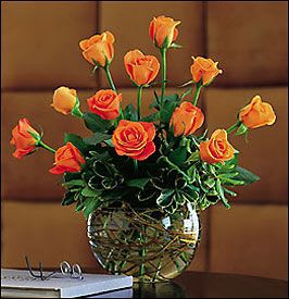 Autumn Rose Bubble Bowl - A warm autumn orange hue and the stylish round bowl filled with curly willow makes this seasonal presentation of roses exceptionally beautiful!