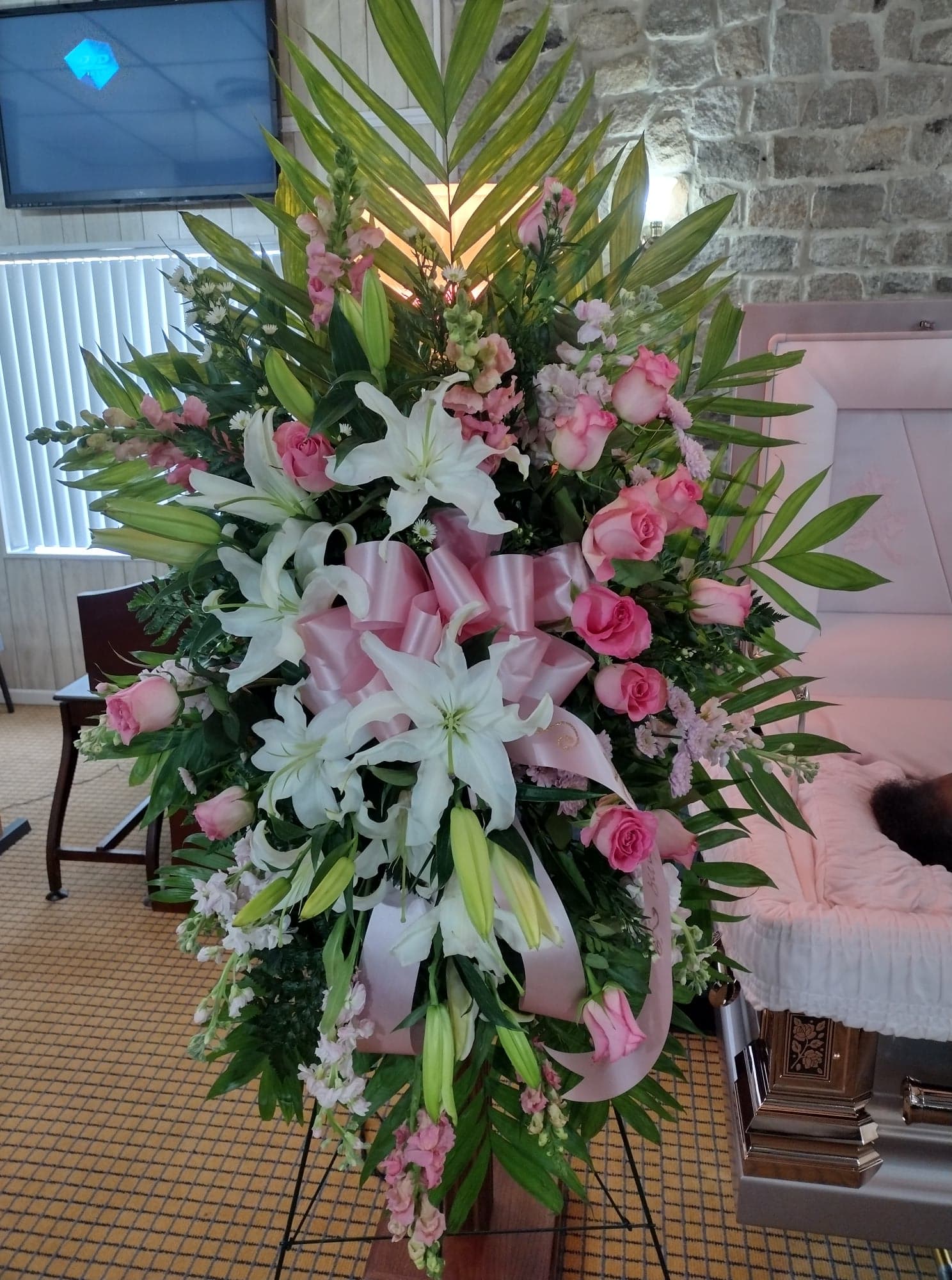 Pink and White Standing Spray Pink and White Standing Spray - Beautiful standing spray with white lilies, pink roses, pink/white stock added with lush greenery make this spray stand out among the rest.