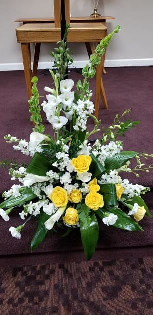 Peaceful Moment Funeral Arrangement - Beautiful bouquet of all white assorted flowers with yellow roses for special presentation of love. This arrangement can be done in any color.