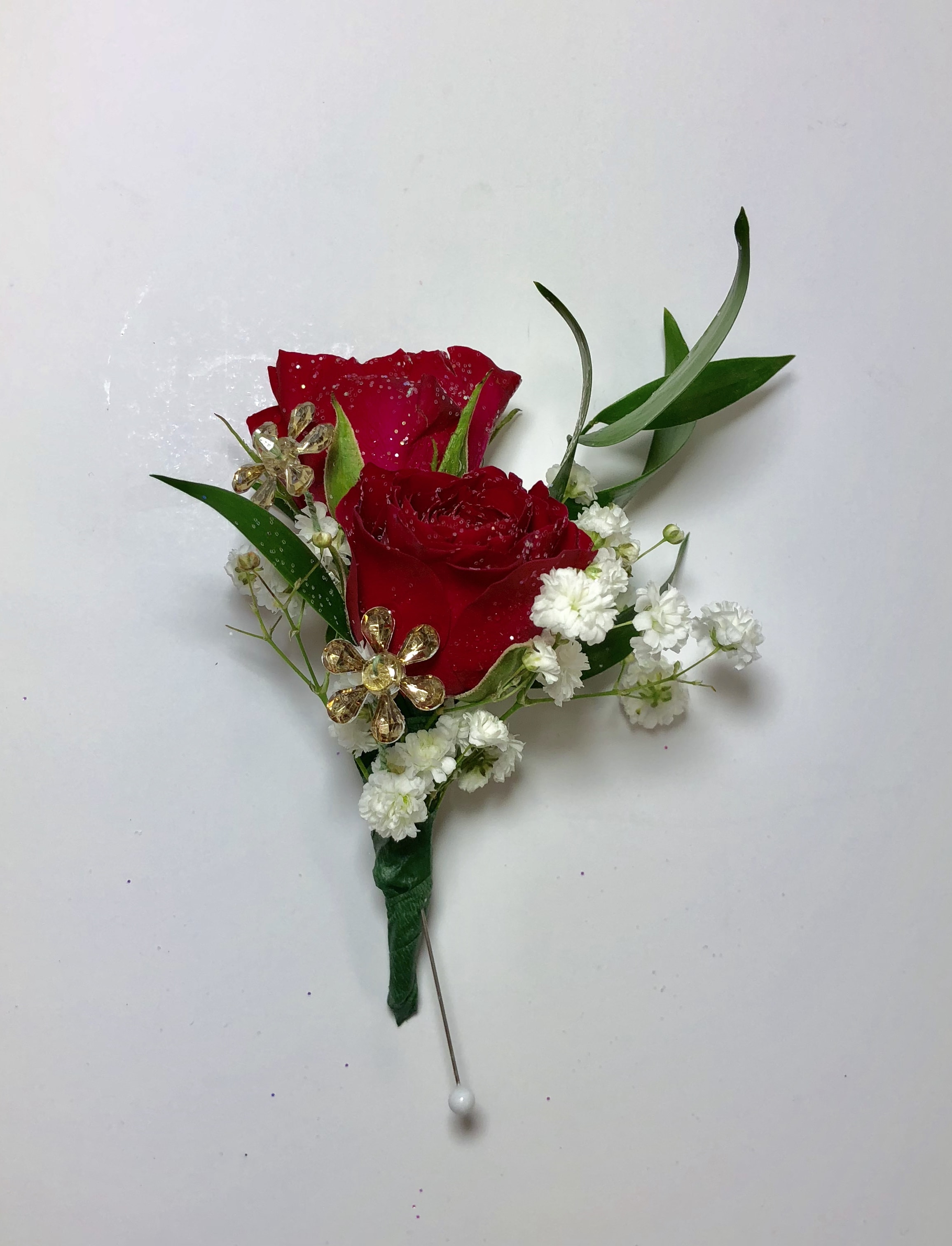 B8 Double Spray Rose Boutonniere B8 Double Spray Rose Boutonniere - Two lovely spray roses complete this design. Sparkling jewels accent this boutonniere. Each boutonniere is customized to coordinate with his date's flowers and her amazing dress.