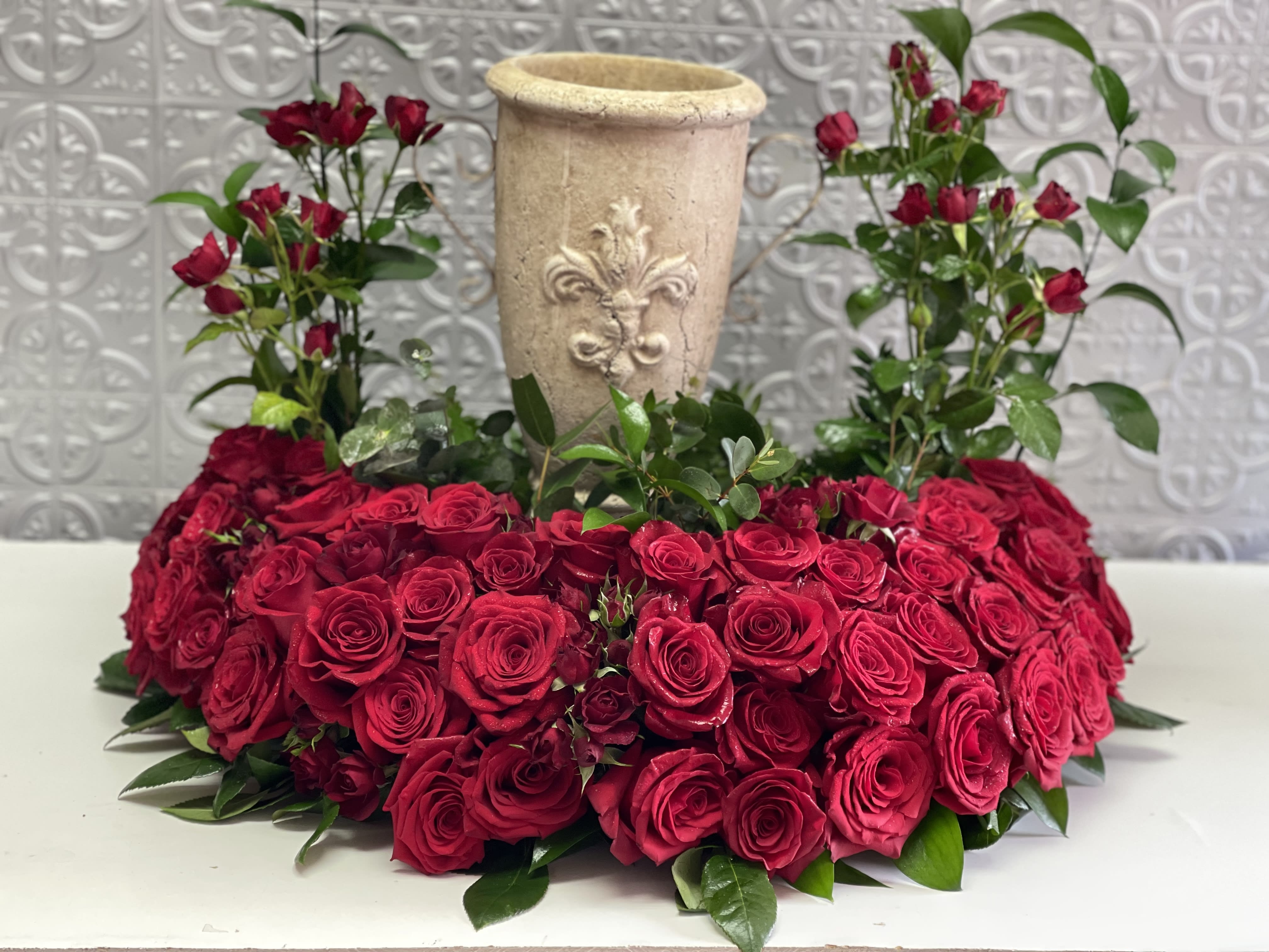 Forever in our thoughts - Pure red roses and greenery come together to create this beautiful urn arrangement . Celebrate and honor your love one with this beautiful urn wreath. (can choose any other color)