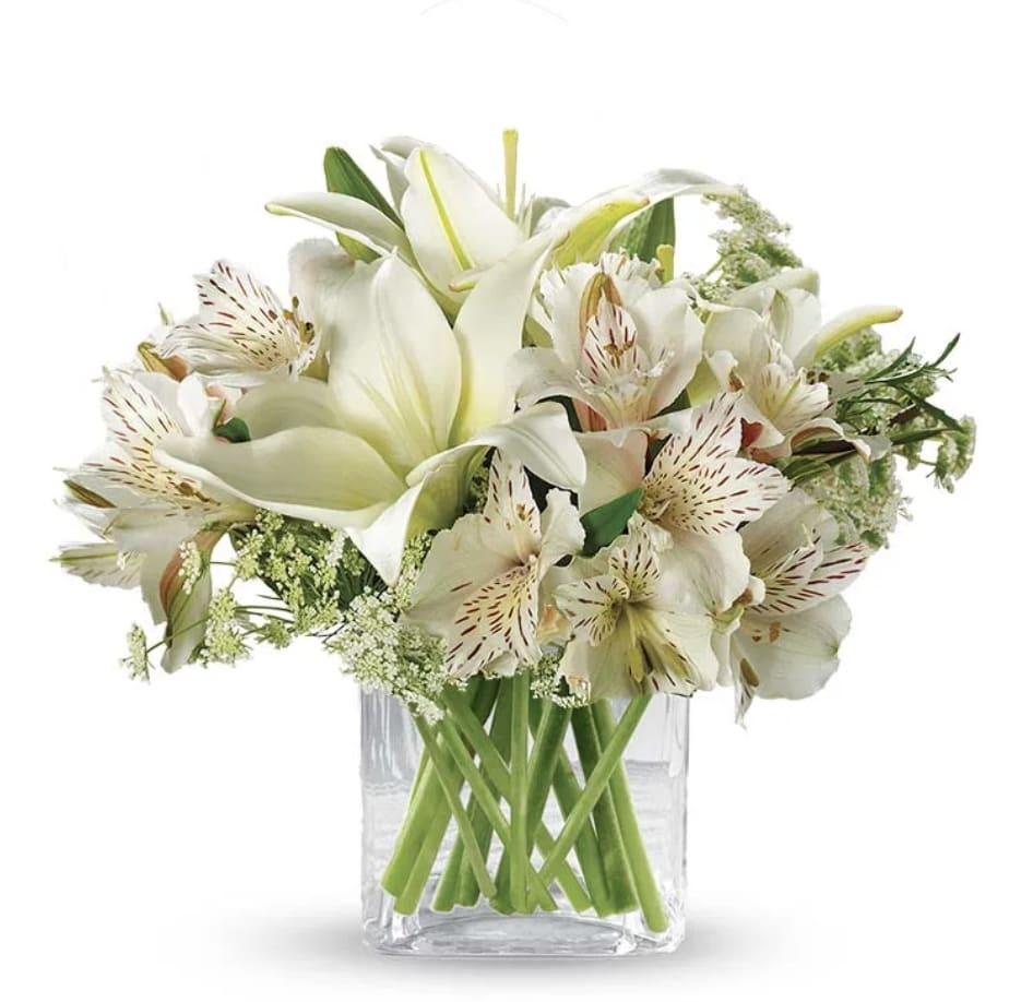 Thinking of You - A beautiful way to send your thoughts, this stunning arrangement features beautiful white lilies, white alstroemeria, queen anne's lace, lily grass, and curly willow in a clear glass cube vase.  Measures approximately 9&quot;H x 10&quot;W x 10&quot;D.   Includes:  • White Lilies  • White Alstroemeria • Queen Anne's Lace  • Glass Vase