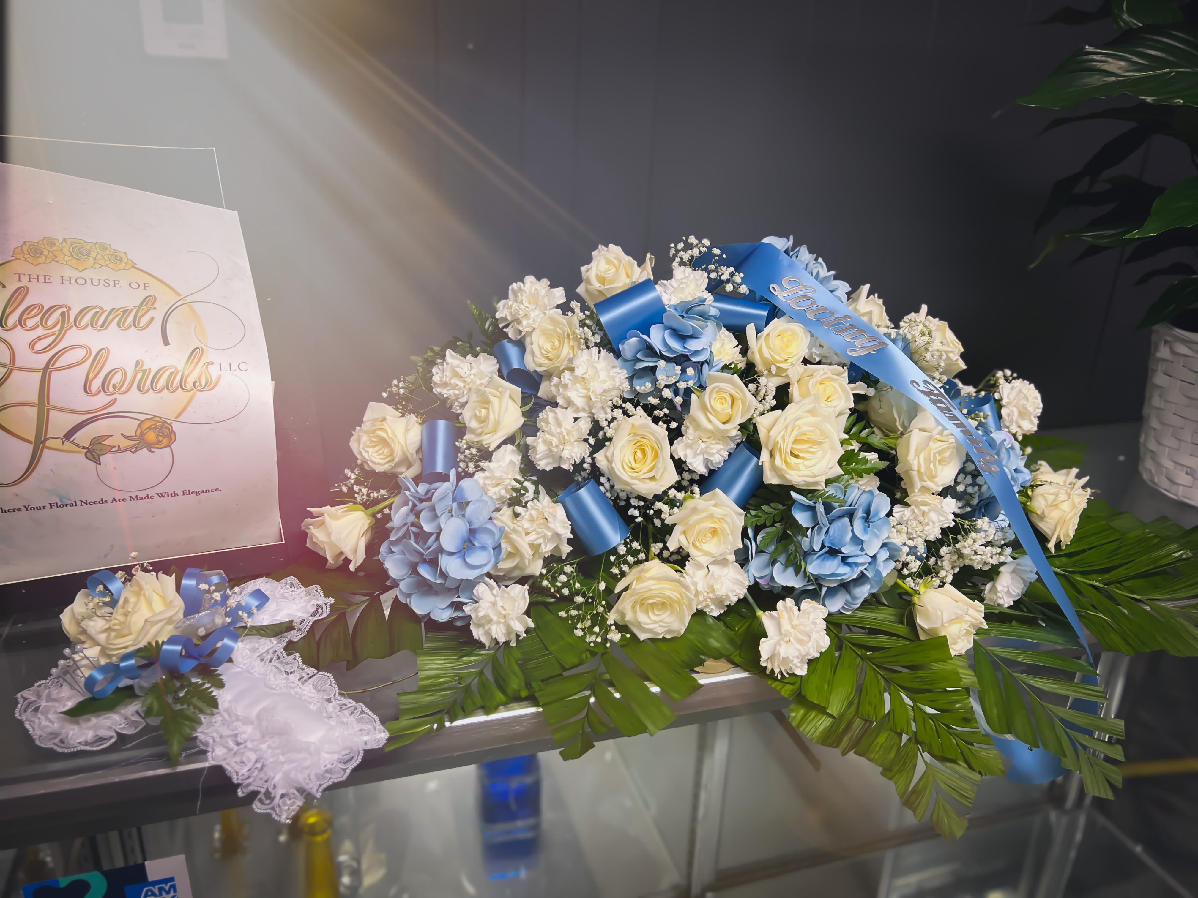 Light Blue Rose Casket Spray - This breathtaking casket spray will add so much elegance to any funeral service. 