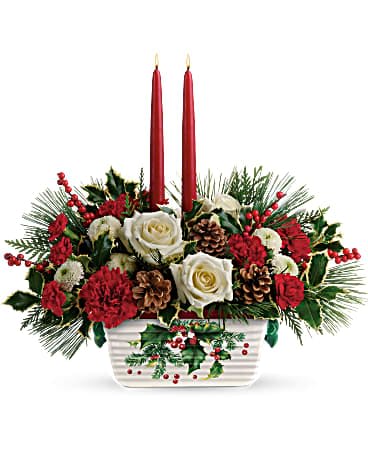 Teleflora's Halls Of Holly Centerpiece - The holiday table shines with this festive centerpiece of roses and winter greens, artfully arranged inside an oven-to-table stoneware serving dish that's hand-painted with a classic holly motif! White roses, miniature red carnations, and white button spray chrysanthemums are accented with flat cedar, variegated holly, and white pine. Delivered in a Halls Of Holly dish.   Orientation : All-Around  All prices in USD ($)  Standard  T18X100A  Deluxe  T18X100B  Premium  T18X100C