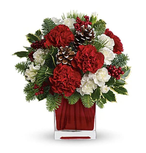 Make Merry By Teleflora - Deliver a winter's day delight. This sweet bouquet includes red carnations and white carnations beautifully arranged in our bright red glass cube. Red carnations and white miniature carnations are accented with tips of noble fir, white pine, holly and assorted greens. Delivered in Teleflora's bright red glass cube.   Orientation : One-Sided  All prices in USD ($)  Standard  TWR04-1A  Deluxe  TWR04-1B  Premium  TWR04-1C  