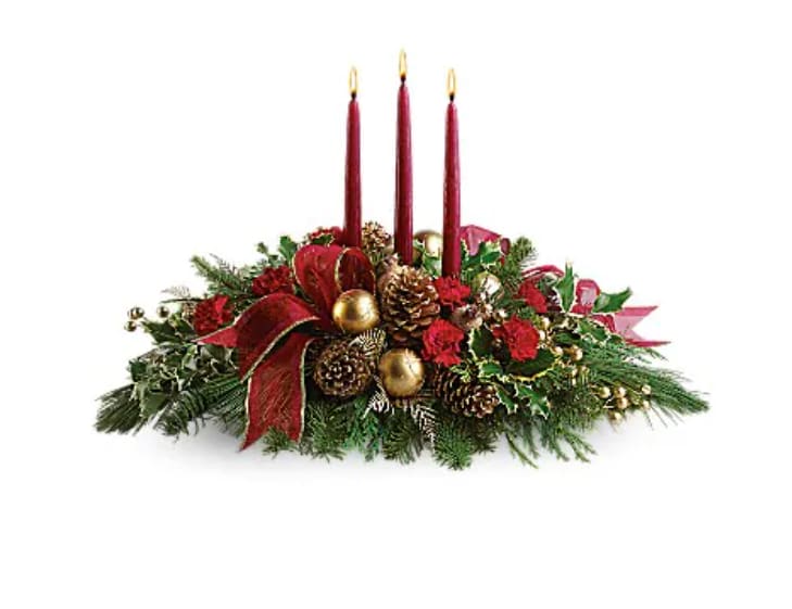 All Is Bright - All will be bright this season when you order this joyful Christmas arrangement. A lovely centerpiece, it will light up the holiday festivities beautifully. Roses and spray roses are artfully on display with merry touches like shimmery ornaments, pinecones, berries, organza ribbon and holiday greens. Three graceful red taper candles add the perfect magical touch.   Orientation : All-Around  All prices in USD ($)  Standard  T114-1A  Deluxe  T114-1B  Premium  T114-1C