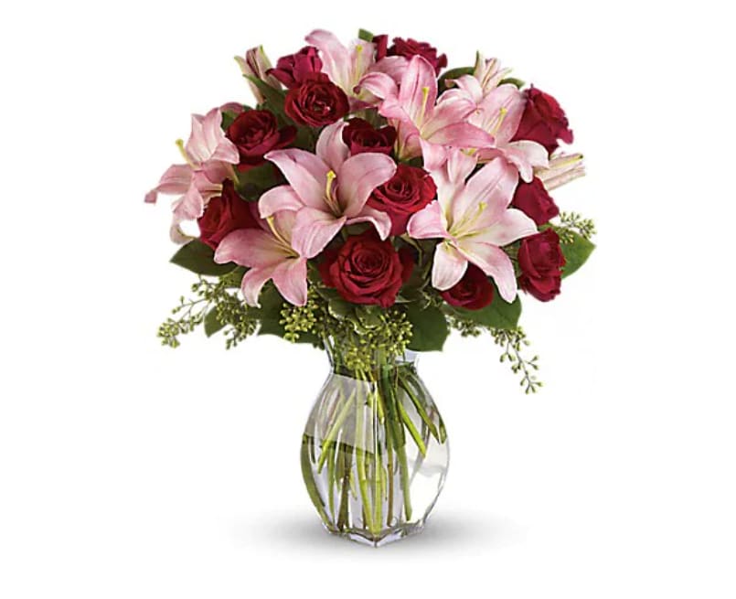 Lavish Love Bouquet With Long Stemmed Red Roses - Lovely reds and pinks come together in this lavishly romantic anniversary gift. Sweetly sentimental, this combination of colors and flowers is a delightfully fresh way to say &quot;I love you.&quot; The spectacular bouquet includes red roses, red spray roses and light pink asiatic lilies accented with assorted greenery. Delivered in a clear glass reception vase.   Orientation : One-Sided  All prices in USD ($)  Standard  T5-1A  Deluxe  T5-1B  Premium  T5-1C