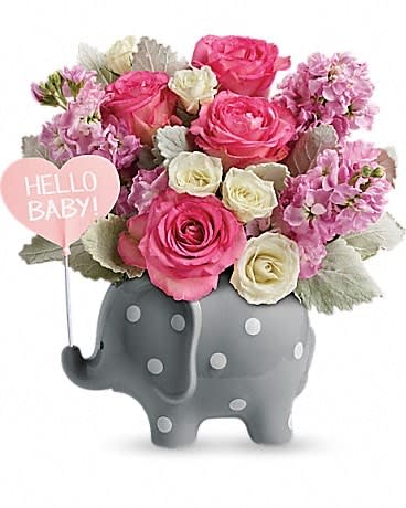 Teleflora's Hello Sweet Baby - Pink Teleflora's Hello Sweet Baby - Pink - Welcome her with open arms, and ears! This sweet ceramic elephant is polka-dotted to perfection and arranged with an elegant array of pink blooms. This adorable gift features pink roses, white spray roses, pink stock, and dusty miller. Delivered in a Hello Baby Elephant.