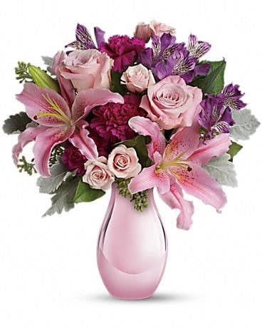 Enchanting Pinks by Teleflora Enchanting Pinks by Teleflora - Imagine her joy when she opens the door and sees this incredible array of roses, lilies and other favorites in an elegant pink reflections vase. She'll be talking about it for weeks. The exquisite bouquet includes pink roses, light pink spray roses, light pink oriental lilies, purple alstroemeria and fuchsia carnations accented with assorted greenery. Delivered in Teleflora's exclusive pink reflections vase.
