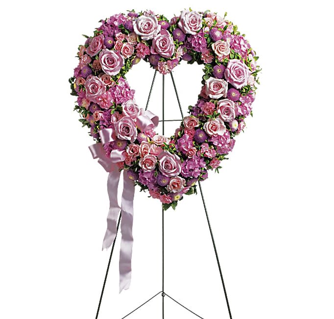 Rose Garden Heart - In the shape of a heart, and accented with a pink satin ribbon, this garden of delicate blooms is a tender and classic tribute to a precious life, and a cherished expression of love and sympathy.