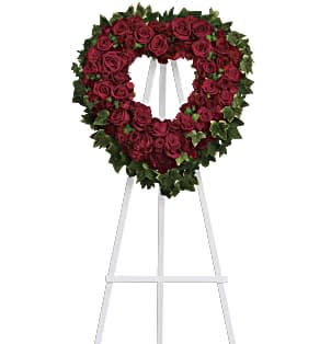 Blessed Heart Sympathy - Make a strong, stylish statement of love with this beautiful heart-shaped wreath. Presented on a funeral easel, the rich red rose sympathy arrangement is a lovely standing spray to place on the altar or by the entrance to the service.