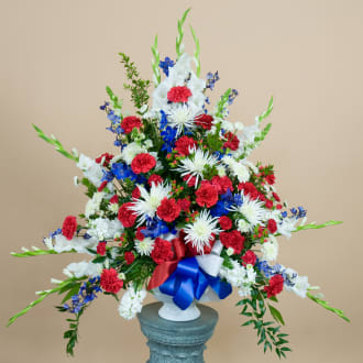 Veteran Vase Arrangement - A traditional vase arrangement in red, white and blue flowers to honor your loved ones service and memory.