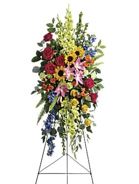 Love Lives On Spray - A bold, bright tribute, this rainbow of blooms fills the room with a spirit of hope and joy. What a glorious celebration of a love that will live on forever.