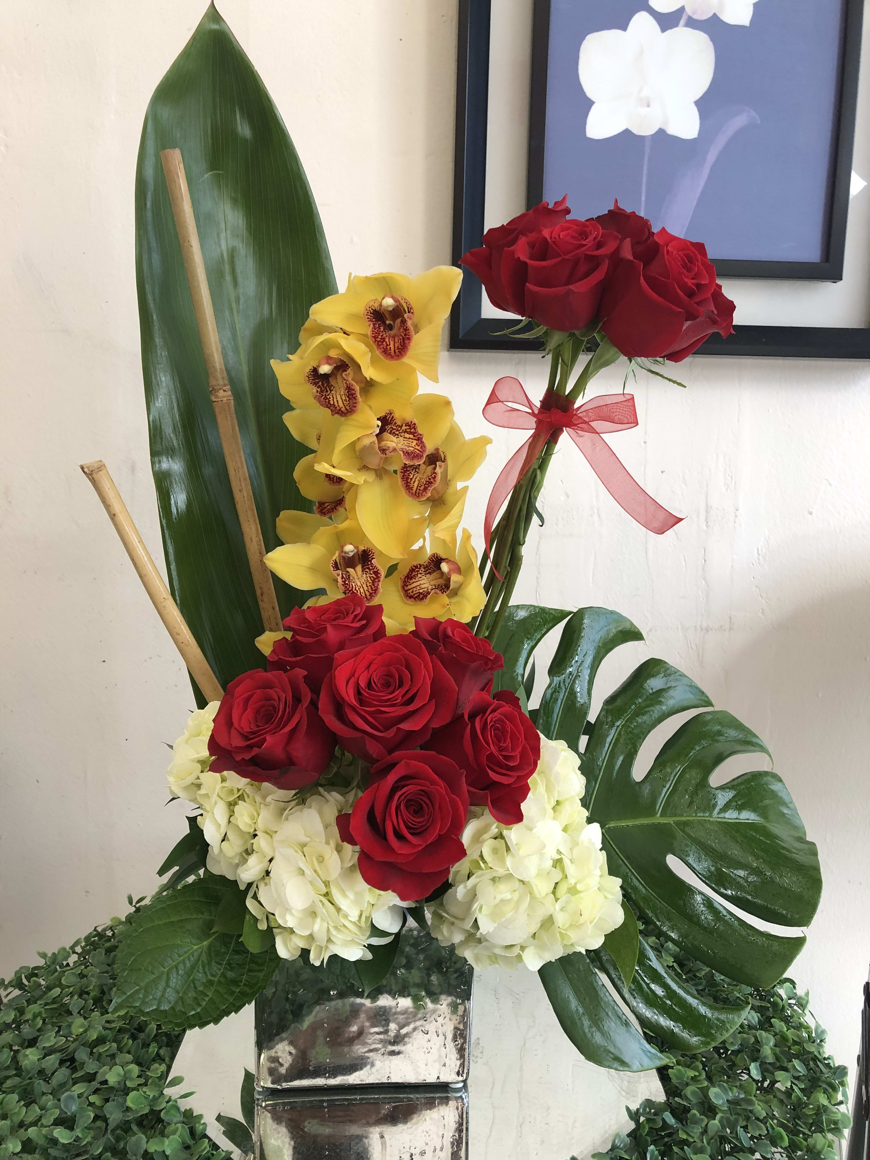 Red Royalty  - Breathtaking arrangment of Yellow Cinbidium, red roses, white hyndrageas and different types of greens that will impress anyone. 