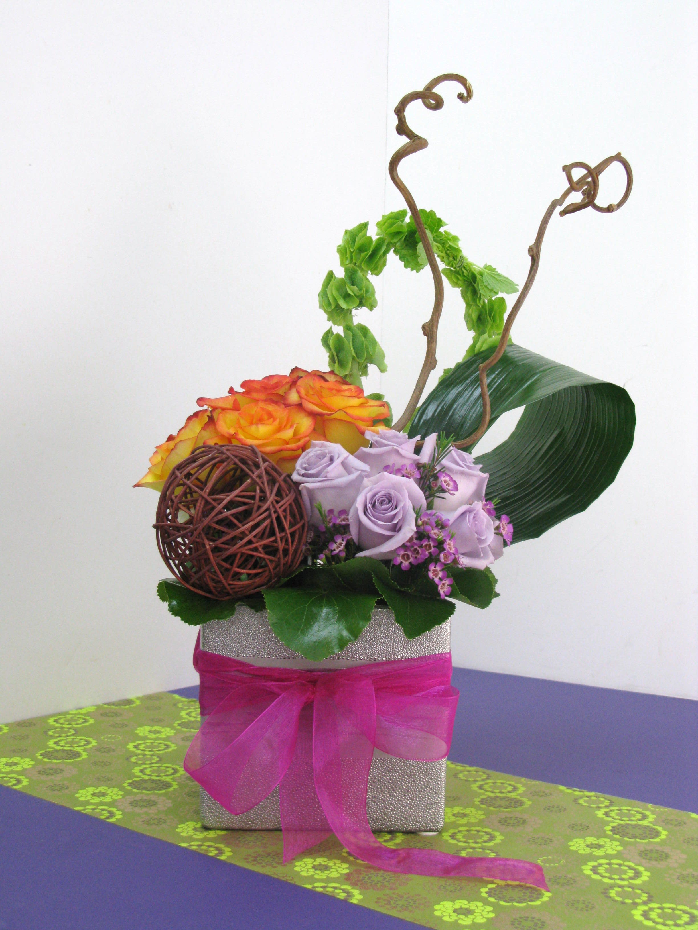 Sweet Dreams Sweet Dreams - Combination of orange and purple roses and Ireland bells and wax flower. This Unique Design with a touch of sweetness, very colorful and classic.