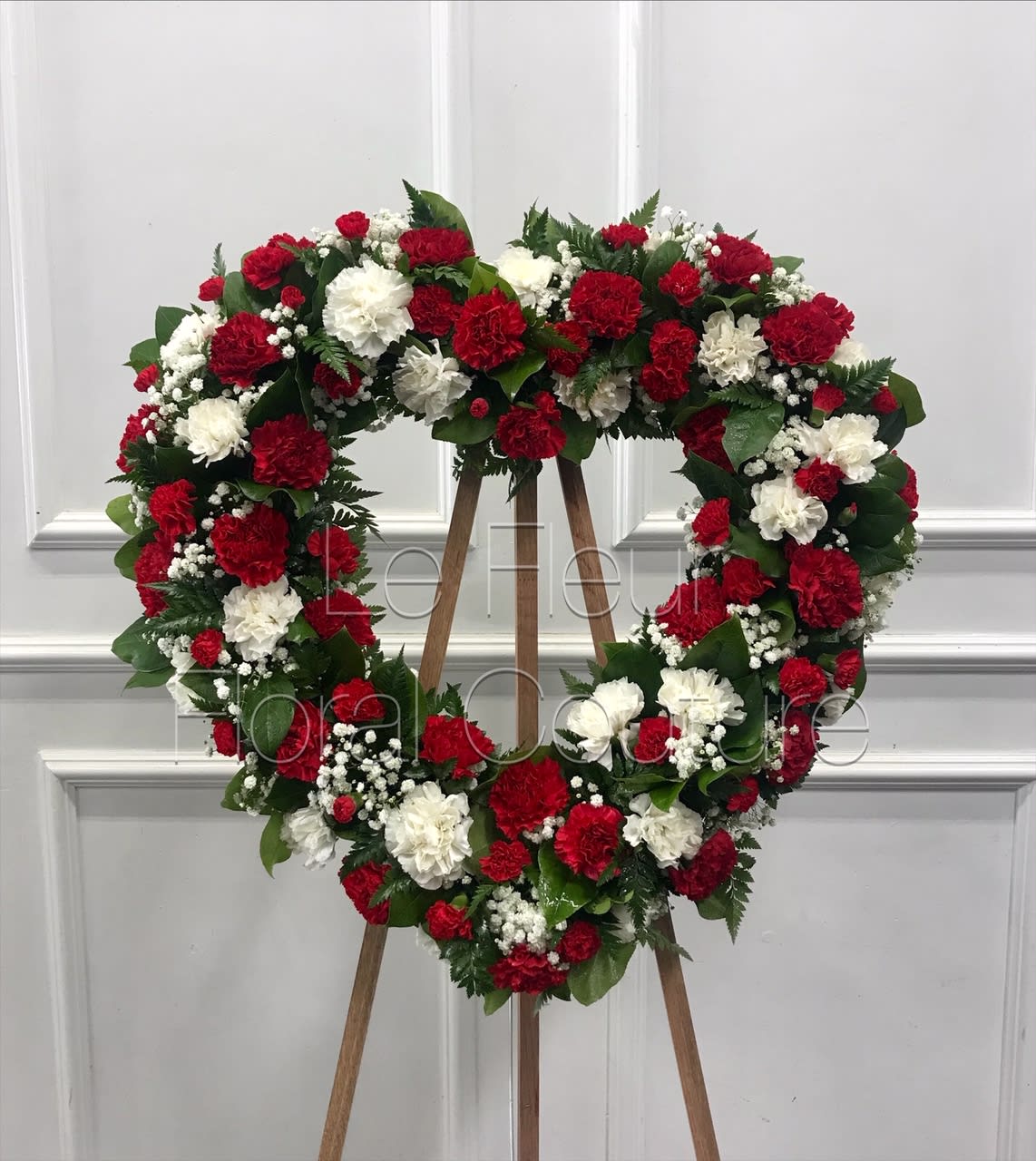 Crimson & White Carnation Heart Crimson & White Carnation Heart - A beautiful open heart of crimson red and white carnations, accented with babies breath and various greens.
