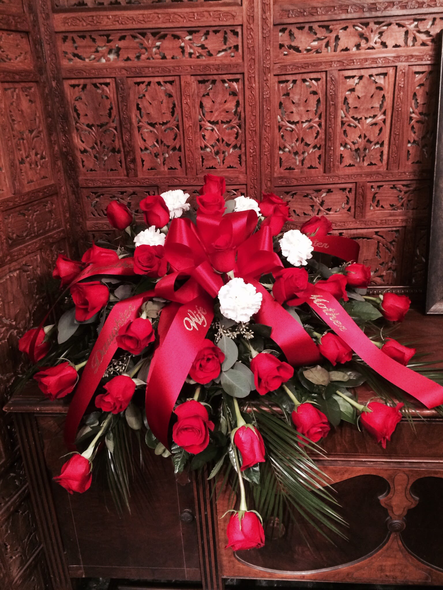 Casket spray red roses, white carnations - This can be made in other colors