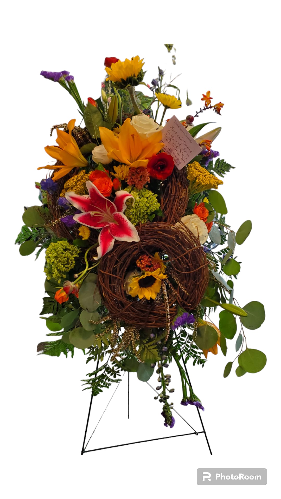Grapevien Easel - A beautiful mix of flowers arranged on an easel with some grapevine incorporated. 