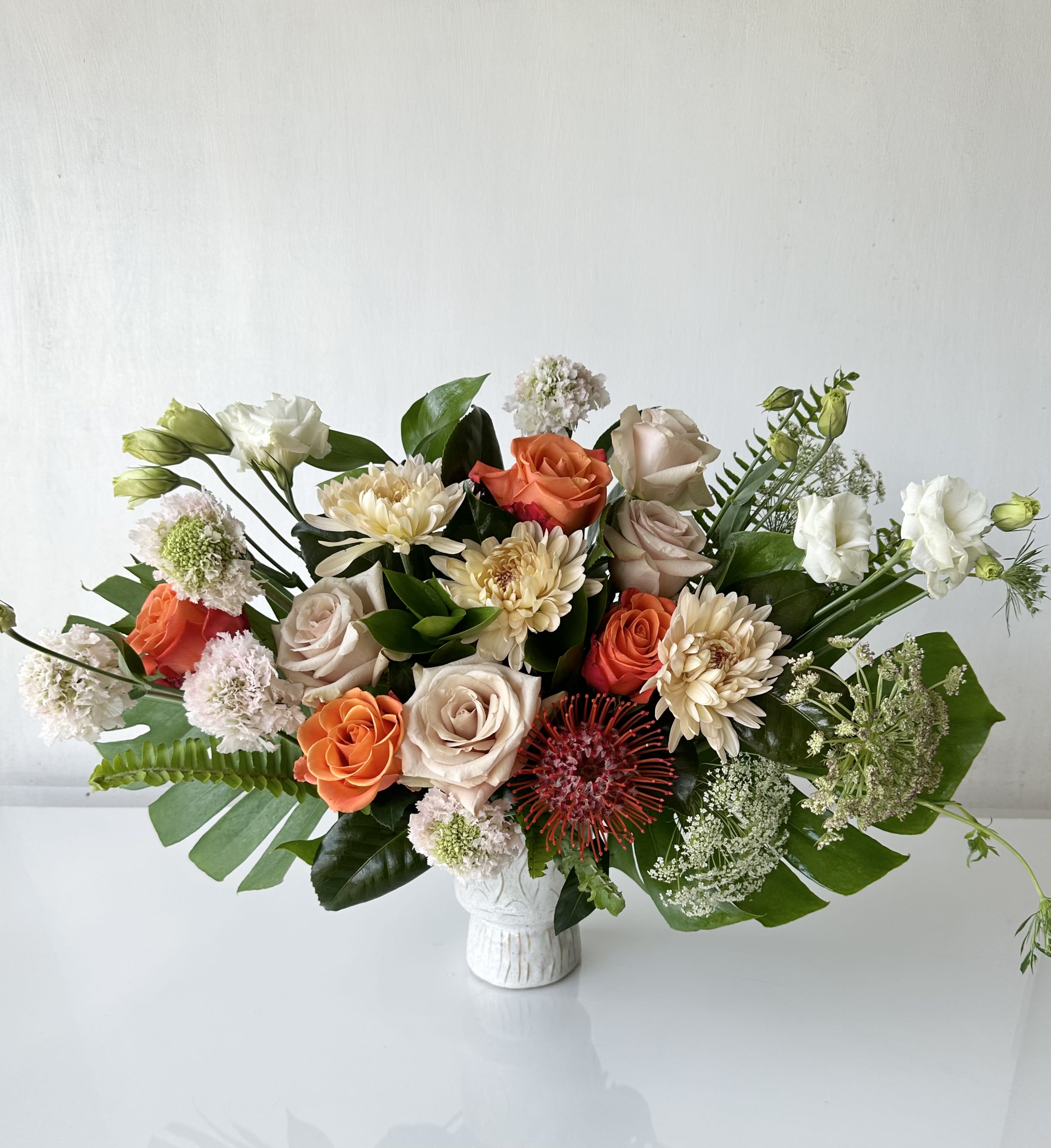 Nature's Bounty - An arrangement of fresh cut flowers includes roses, scabiosa, pin cushion, Cremon, spray roses, lisianthus, queen ann's lace, and premium greenery.  Dimensions: Approximately 18&quot; H x 24&quot; W