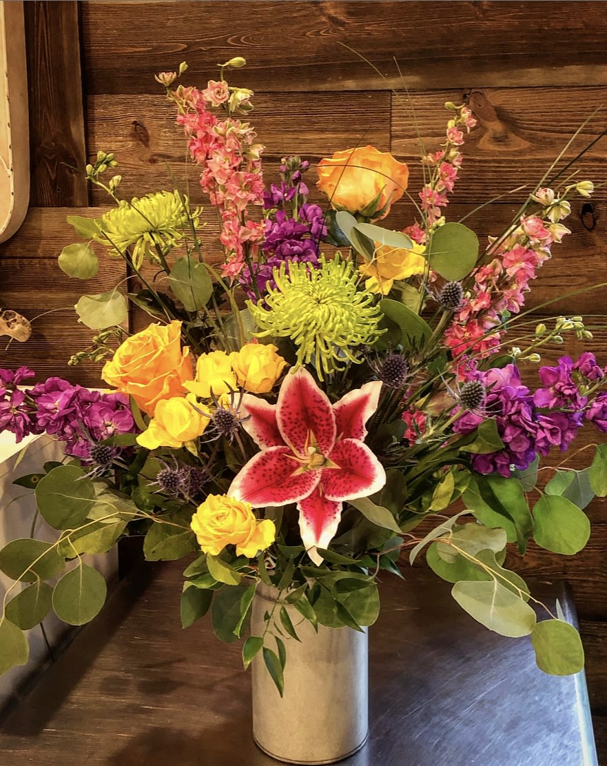 Grandstand Grandstand - A grand display of bright and colorful flowers, including lilies, roses, mums, thistle, and larkspur. A great bouquet if you're looking to show off.  Approx. 31" T x 21" W