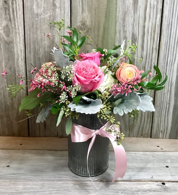 Blushing Beauty Blushing Beauty - In a tin vase, a mix of beautiful blush and white spring flowers including roses, and hydrangea with a mix of greenery and accent flowers.