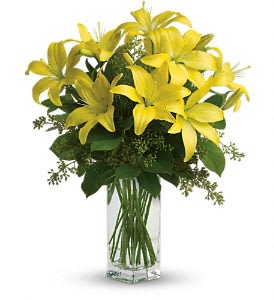 Teleflora's Lily Sunshine - When it comes to spring flowers, the lily reigns supreme. It's easy to see why in this gorgeous bouquet of bright yellow blooms.