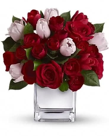 Teleflora's It Had to Be You Bouquet - She's your one and only. Doesn't she deserve an equally singular bouquet? This charming, heartfelt arrangement puts a feminine spin on classic red roses by mixing in elegant red and pink tulips. Presented in our modern Mirrored Silver Cube, it's a uniquely stunning selection for any day you want to pamper your special one. This unique bouquet mixes large red roses and red spray roses with pink and red tulips. The flowers are delivered in our exclusive Mirrored Silver Cube vase.