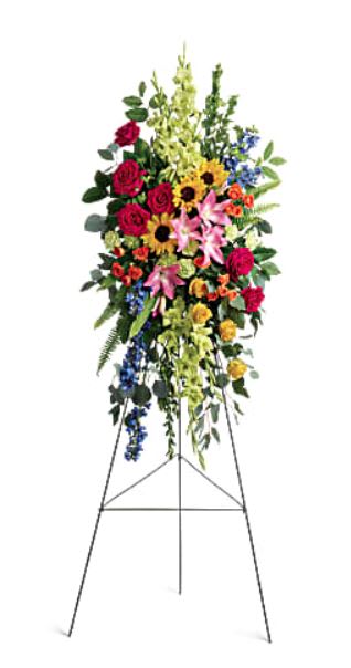 Love Lives On Spray Love Lives On Spray - Bursting with joy, this radiant spray of rainbow blooms is an exuberant tribute to never-ending love.