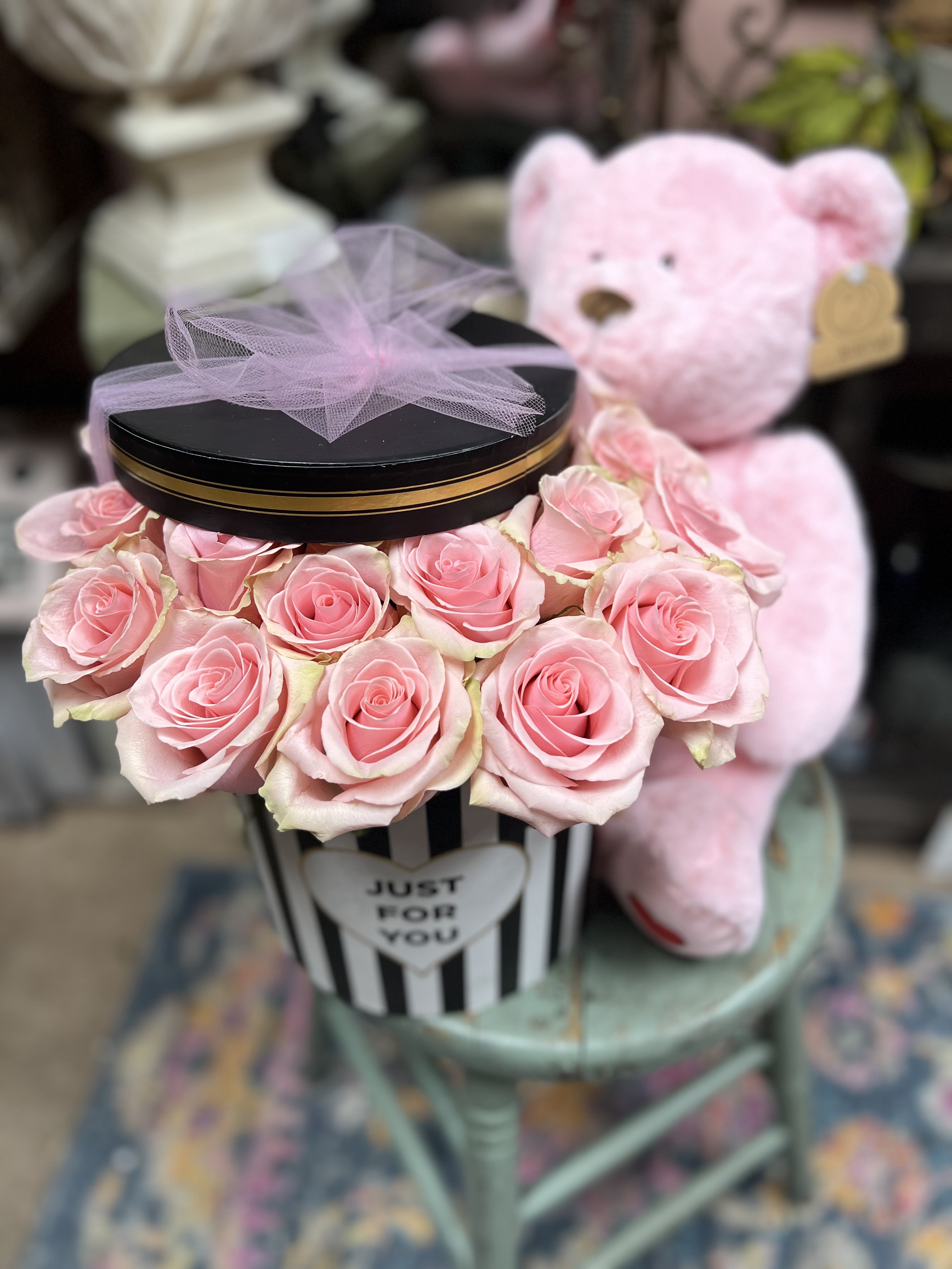 PINK PETALS IN A BOX  - 24 Premium Pink Roses (pink tone will vary) in round design box with lid (box design and pattern will vary) Roses inserted in wet foam infused with plant preservative to preserve life of floral).  Bear NOT included but can be added to order as add on option