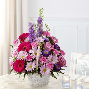 The FTD® Pastel Peace™ Basket - The FTD® Pastel Peace™ Basket is a sweet and simple way to offer your condolences. Lavender roses, fuchsia gerbera daisies, lavender daisies, purple larkspur, purple matsumoto asters, pink mini carnations and lush greens are arranged to perfection in a round whitewash handled basket to create a gift that expresses your wishes for sympathy and peace.