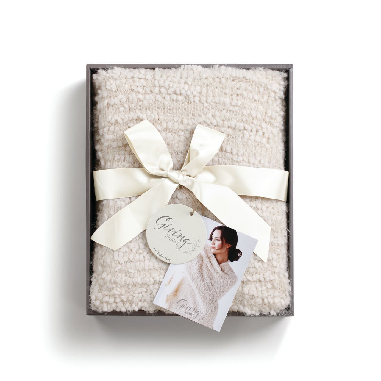Giftable Cream Shawl - Giving Gift Collection - Gift to a friend or loved one to let them know you're thinking about them and you care. Each shawl is crafted from soft fabric designed for soothing comfort and presented in a beautiful gift box. Two deep pockets let you keep your must-haves close by for comfy ease. This incredibly comfortable cream Giving Shawl includes a message of encouragement printed on a keepsake bookmark.  Packaging sentiment: We all need a little comfort now and then... A reminder to help us know that we are not alone in the world... That there is someone in our corner, ready with a hug, no matter what. Always know you are being thought of, cheered on, and loved for exactly who you are - Someone who is beautiful and wonderfully made.  Size: 27&quot;w x 70&quot;long Materials: nylon