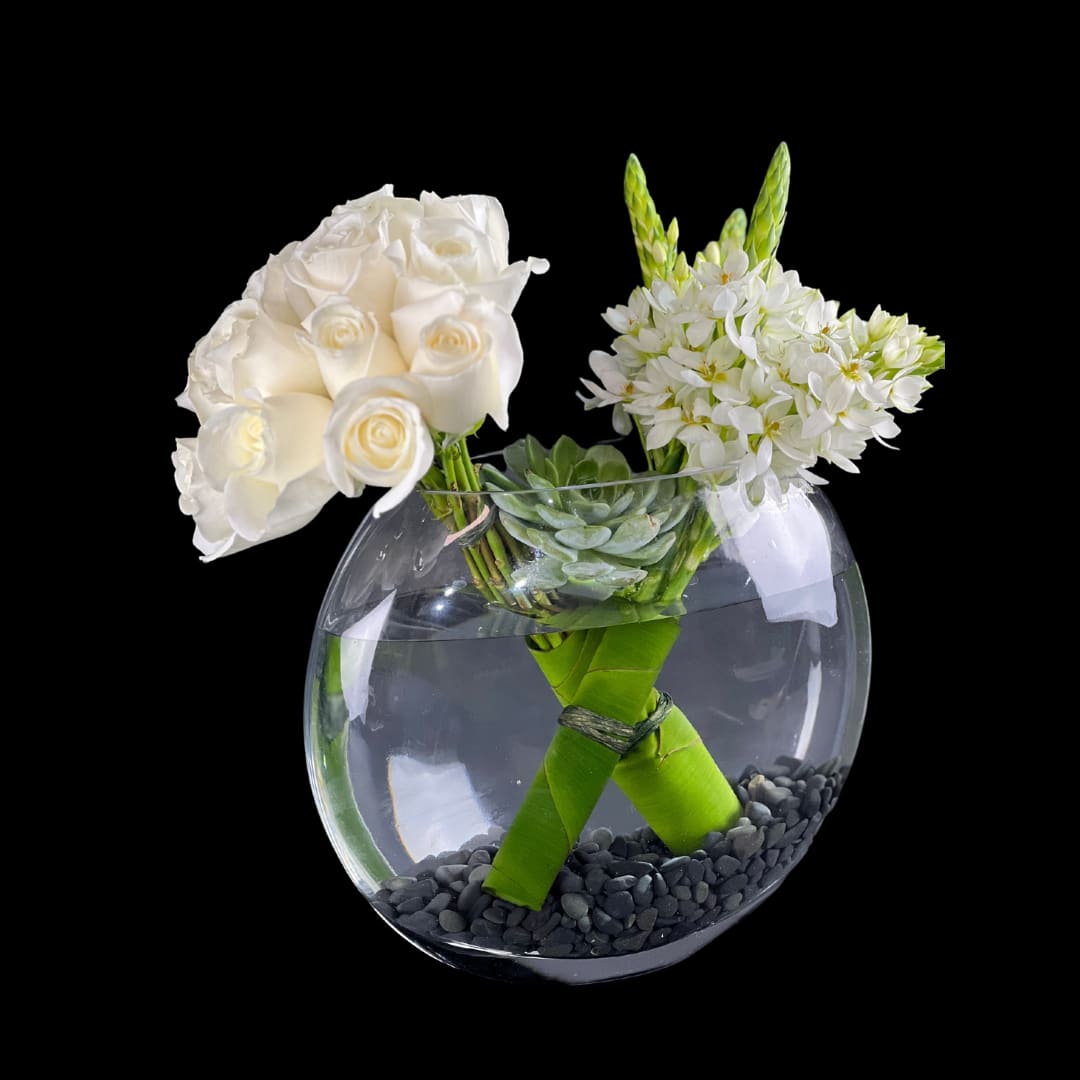 Moonlit Melody Whispering - Fresh cut flower arrangement designed in white color palette with roses and dubium flowers with a floating succulent plant. Designed in a modern clear glass bowl vase.  Vase Dimensions:  9.5&quot; Height x 11.5&quot; Width x 5.00&quot; Depth (clear glass)