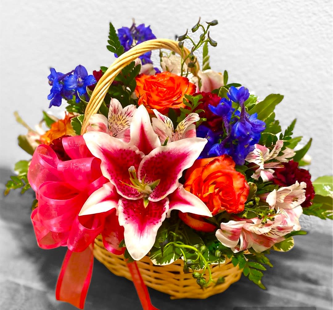 Elegance in bloom Elegance in bloom - This basket design includes Roses, Stargazer Lilies, Delphinium, Alstroemeria, Carnations, and various foliage arranged in a wicker basket. This design measures approx. 14"W x 16"H. Basket may vary.