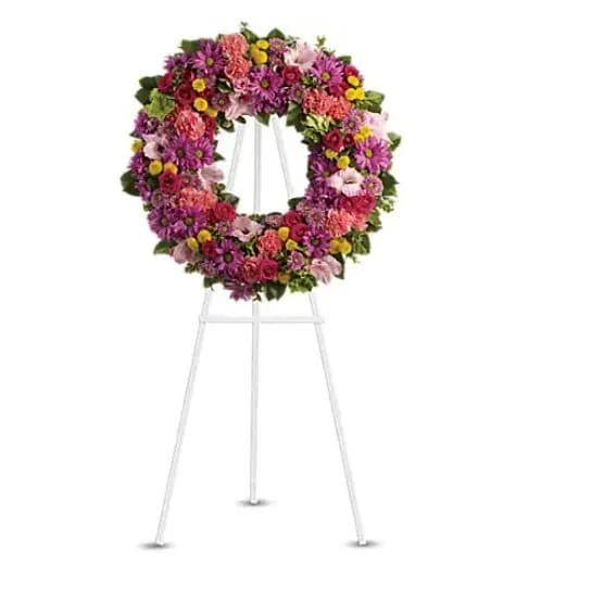 Ringed by Love - The memory of brighter days is always a comfort to those in mourning. This lovely wreath will display your compassion beautifully. A standing wreath of dazzling flowers such as green hydrangea, hot pink spray roses, pink gladioli and carnations along with a mÃ©lange of multi-colored daisy spray and cushion spray chrysanthemums and greenery is delivered on an easel. 