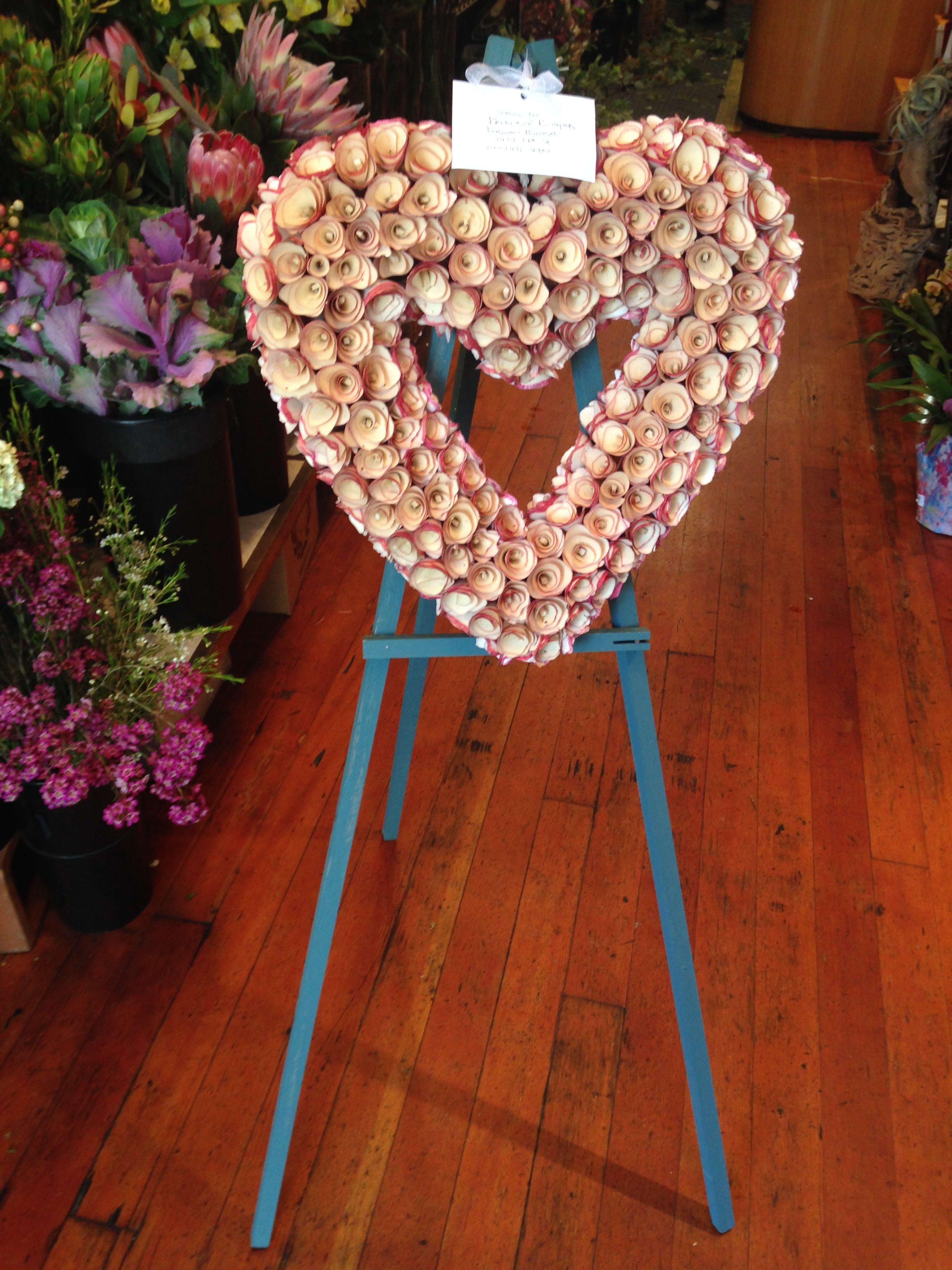 Wood-shaving Heart Spray Wood-shaving Heart Spray - This beautiful heart is made from wood-shavings and will last for years! Available on an easel as a funeral "spray." The heart measures approximately 18 inches across. Featured Wreath: $185.00