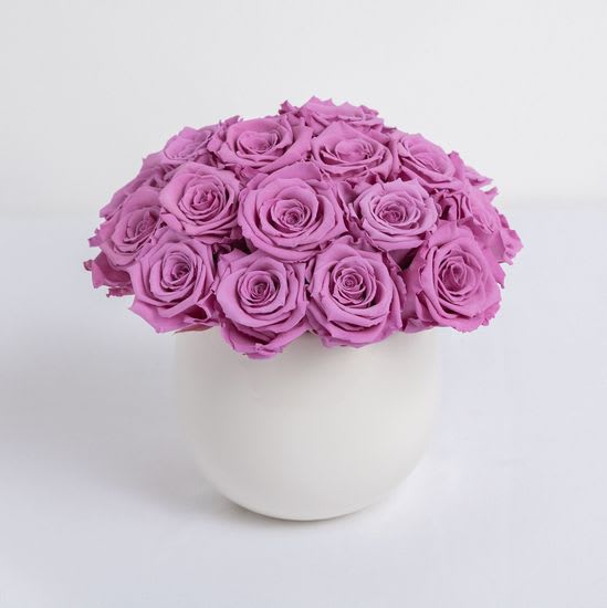 Lavender Preserved Roses - Lasts a full year - Our Classic Preserved Rose Composition includes 20 beautifully lavender preserved roses hand-crafted in a decorative white ceramic bowl style vase. The overall design has a modern yet classic appearance and is a versatile design you're sure to love. Our preserved rose compositions make for a memorable gift for you or someone special!